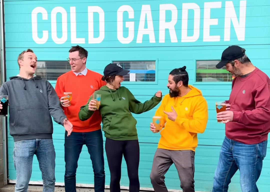 Five friends happily drinking Cold Garden beer together.